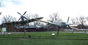 A Spitfire and Hurricaine welcome visitors before they reach the massive hangers.