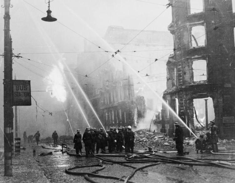 Firemen in Manchester tackle the aftermaths of a bombing raid