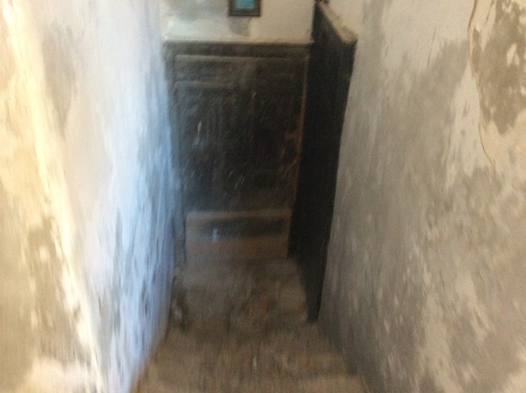 I'm not sure how I ended here. I was just looking around, trying to get into the church above and could here building work. The sign above the door says 