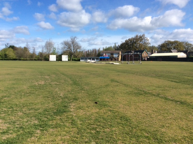 The village cricket ground. The field is still quite lush but you can see the area where the wickets will go is already rock hard and flat.