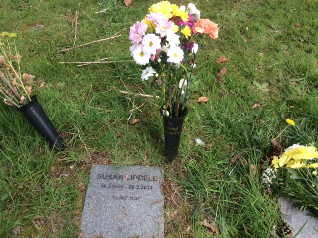 On the way out, I bought some flowers to leave with my mother.  The old ones on the left I left a month earlier at her birthday. 