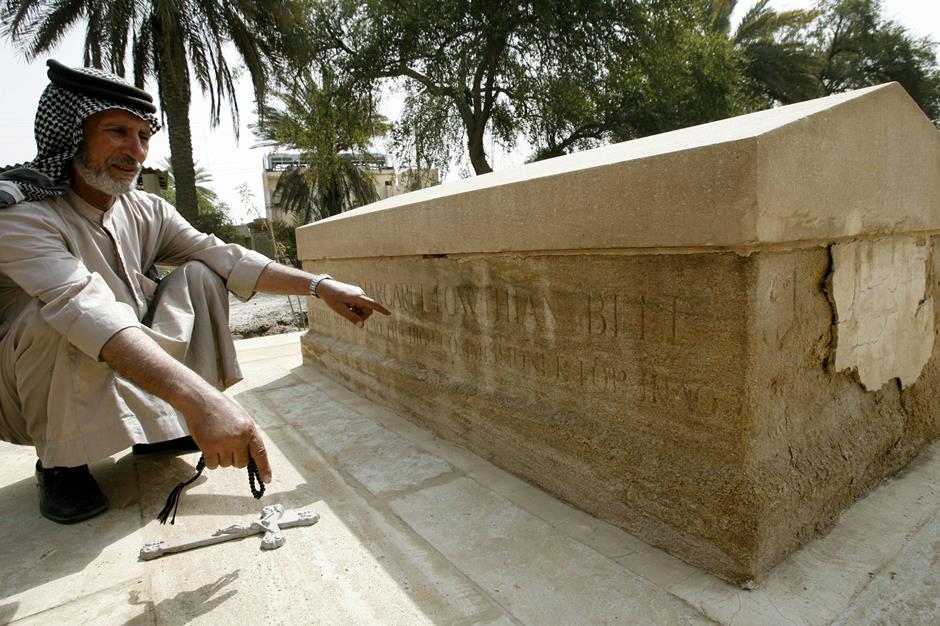 Iraqi groundskeeper Ali Mansur at the old Christian cemetery in Baghdad points to the tomb of Gertrude Bell.