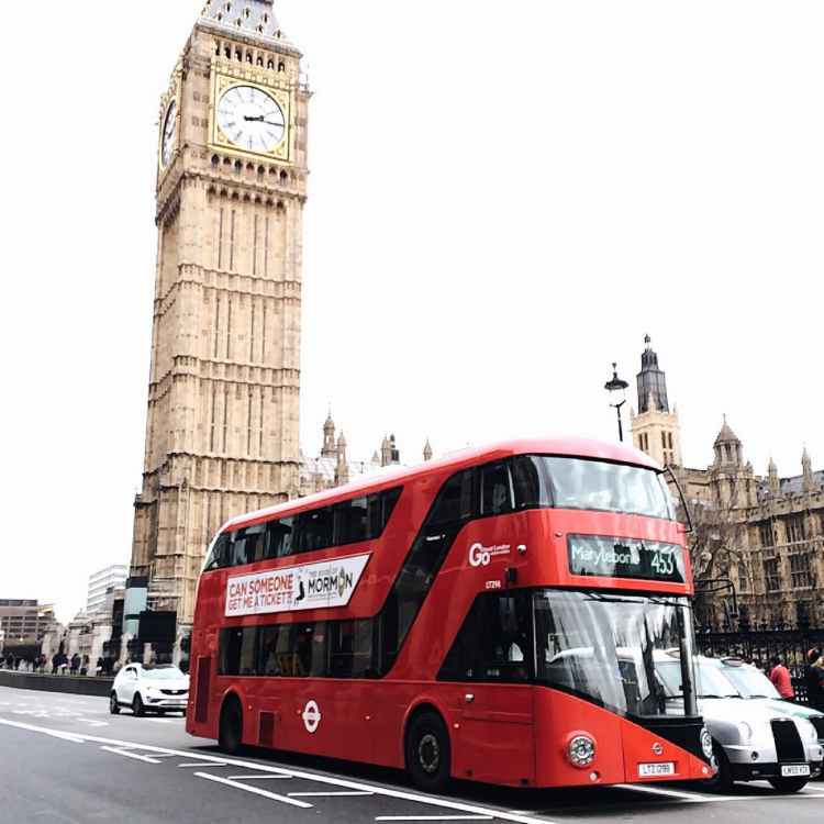 red bus on road near big ben in london