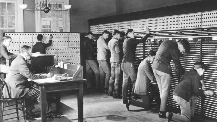 Teenage boys operating a 19th century switchboard.